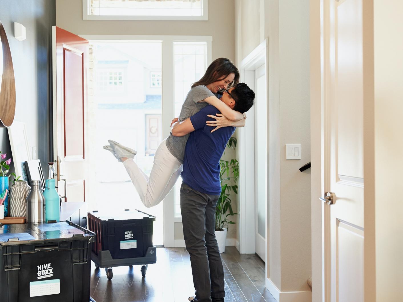 Couple embracing in hallway of a house