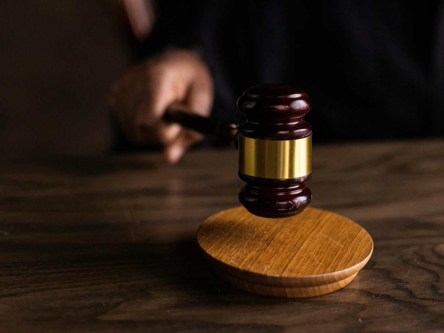 Brown wooden gavel on brown wooden table