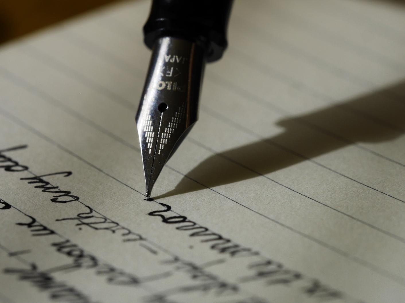 Fountain pen writing on a piece of lined paper