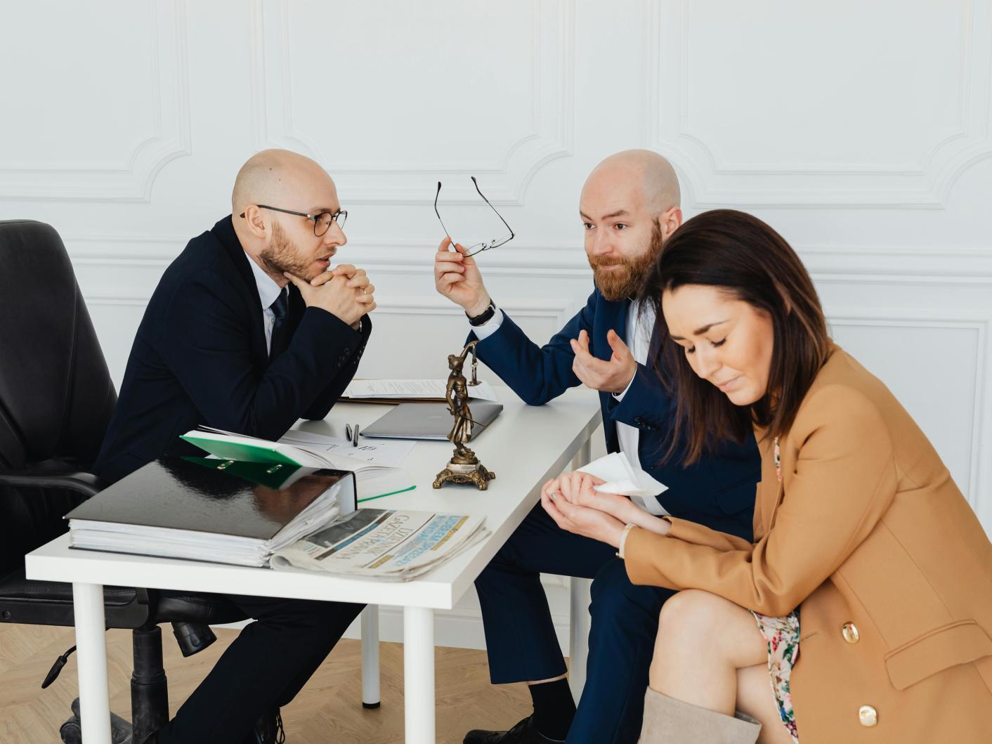 A couple in a mediation hearing with a solicitor