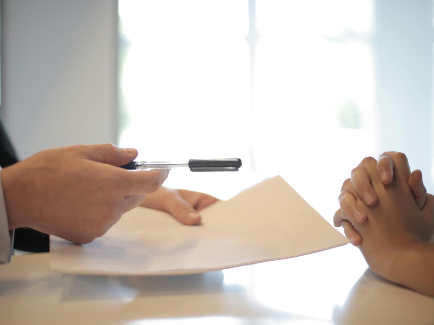 Solicitor giving a contract to woman to sign