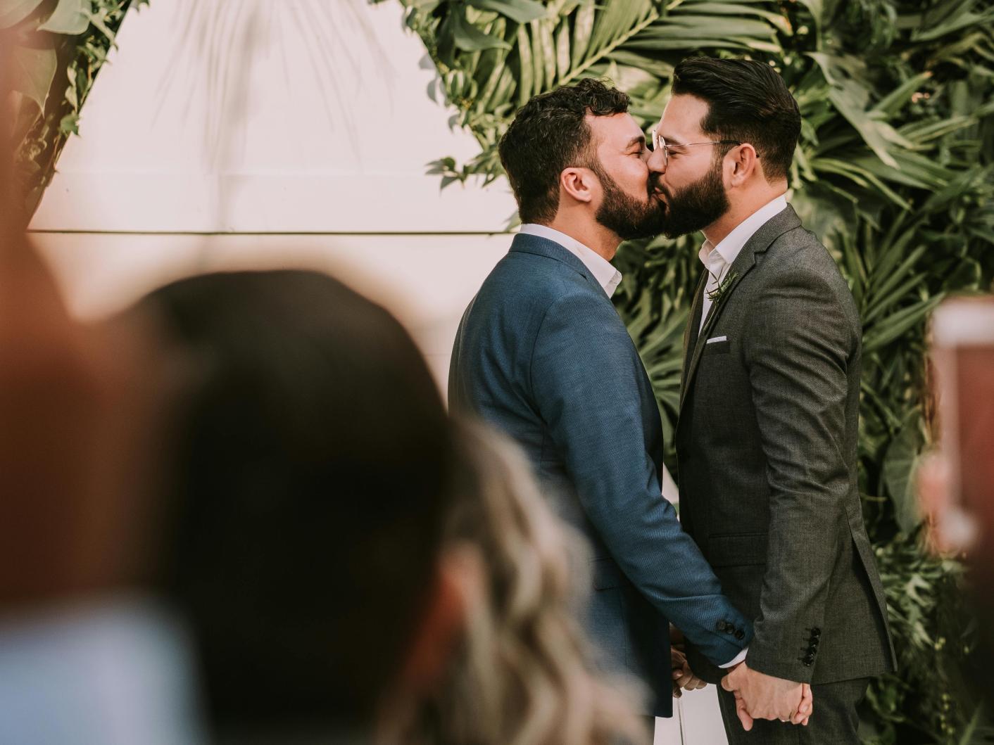 Men getting married in front of guests